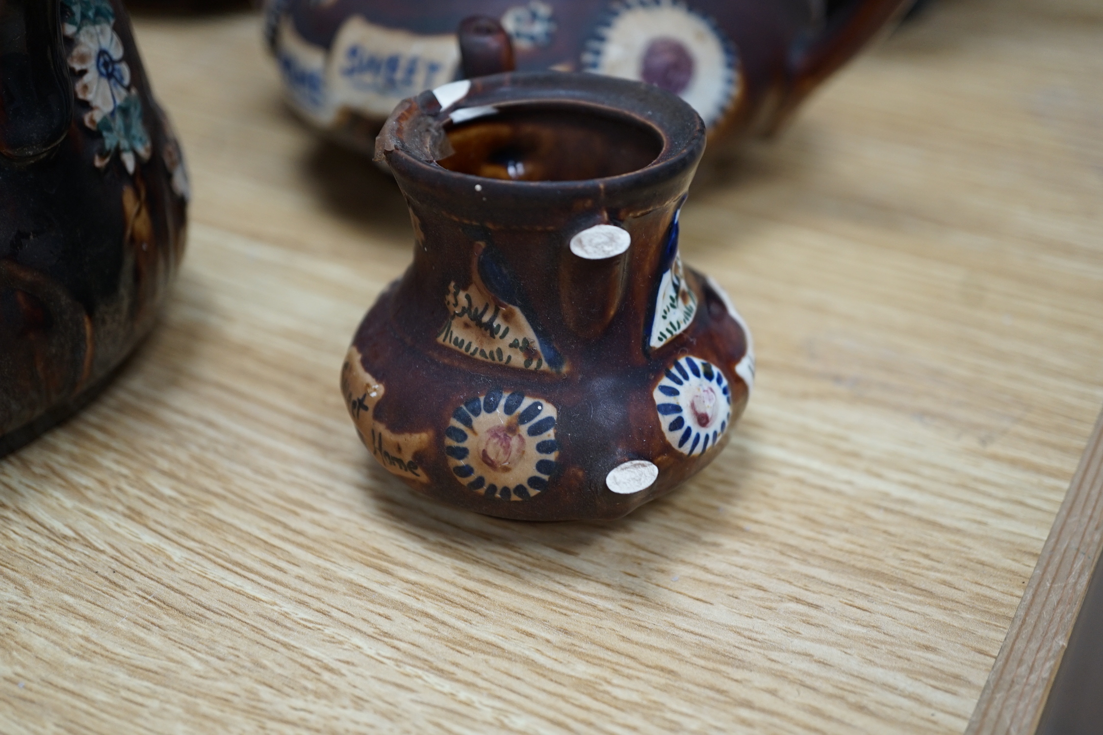 Measham Barge ware glazed pottery including teapots and jugs, decorated in relief, largest 28cm wide